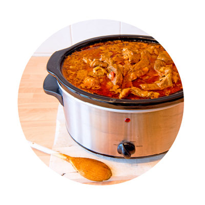 Crockpot with chicken and sauce. Crockpot with chicken and sauce.