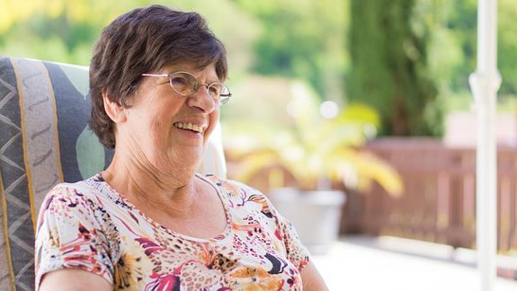 grandma with glasses outside smiling grandma with glasses outside smiling