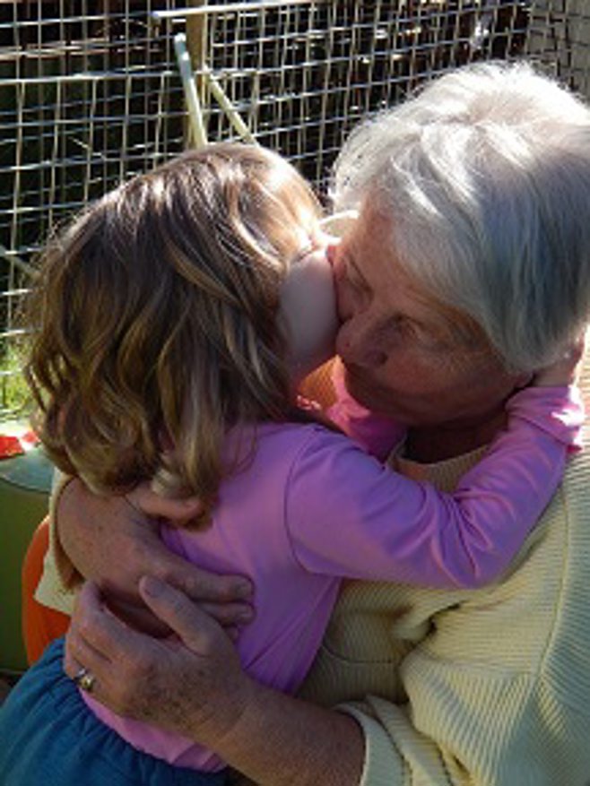 child gives grandma kiss 
