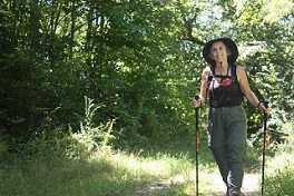 A hiker happily traversing her route A hiker happily traversing her route