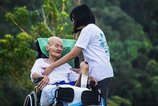 young caregiver taking care of grandma young caregiver taking care of grandma