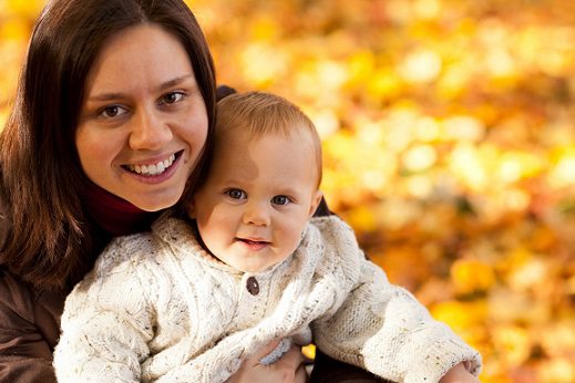 Mother and child in field of orange leaves Mother and child in field of orange leaves
