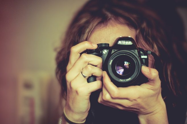 photographer holds nikon photographer holds nikon