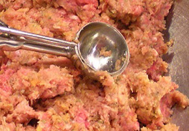 Scooping raw meatball Scooping raw meatball