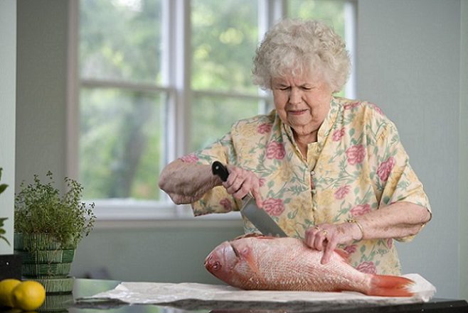 Senior woman prepping fish