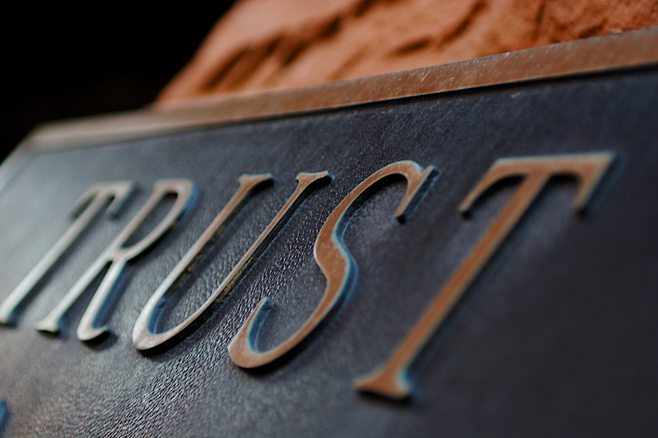 Metal plate with the word trust Metal plate with the word trust