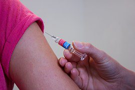 Closeup of child's arm being vaccinated Closeup of child's arm being vaccinated