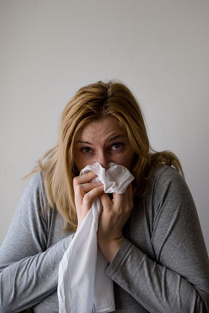 sick woman blowing nose.alert1